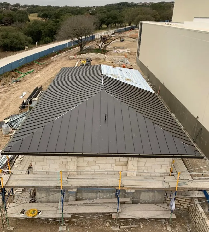 Metal roof new construction with scaffolding in Corinth